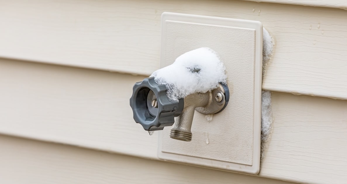 Snow and ice buildup on an outdoor faucet showing the need for plumbing winterization in Metro Atlanta.